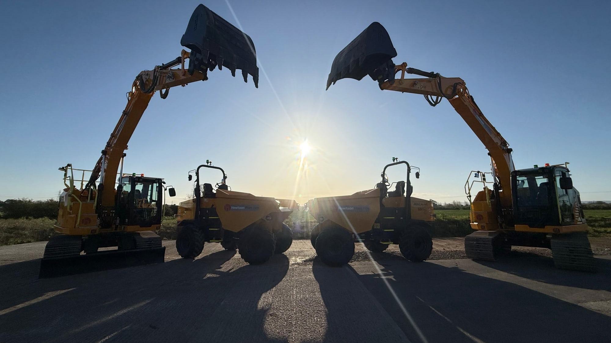 Hewitson excavators silhouetted at sunset